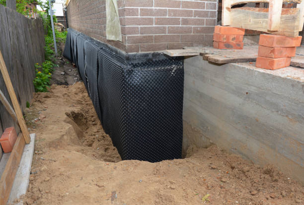 SJ Waterproofing Pros technician performing targeted Wet Basement Repair assessment in Benton Ridge, OH